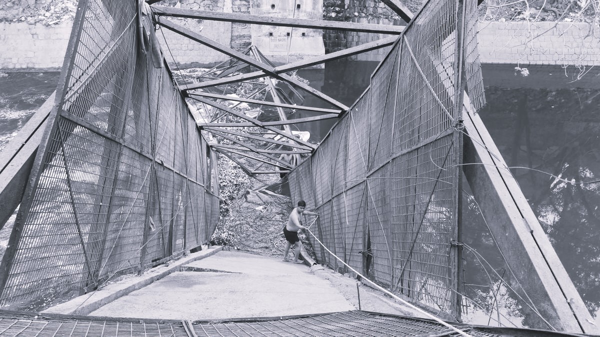 Woman killed after barricaded iron bridge collapses over drain in North Delhi